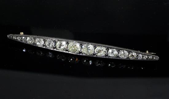 A Victorian gold, silver and graduated old mine cut diamond bar brooch, 85mm.